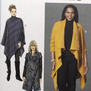 May include: McCall's M7262 sewing pattern featuring three women's fashion designs. The pattern includes a yellow open-front cardigan, a dark gray wrap, and a dark blue poncho. The size range is 18W-24W.
