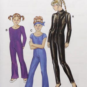 May include: Kwik Sew sewing pattern 3103 featuring illustrations of jumpsuits. The pattern includes sizes 4-5-6-7. The cover shows three jumpsuit designs: a purple jumpsuit, a blue jumpsuit, and a black jumpsuit.