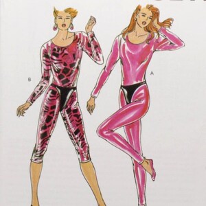 May include: A vintage sewing pattern from Kwik Sew, pattern 1935, featuring illustrations of two figures in pink and black spandex outfits. The pattern includes sizes XS-S-M-L. The cover has the Kwik Sew logo and the designer's name, Kerstin Martensson.