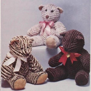 May include: A McCall's Crafts pattern envelope featuring three handmade chenille teddy bears. The bears are in shades of brown, white, and pink, each with a ribbon. The envelope has the text "McCall's Crafts" and "Faux Chenille".