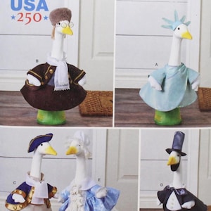 May include: Simplicity pattern S3224 featuring goose figurines dressed in various costumes. The geese are wearing outfits such as a brown coat, a Statue of Liberty-inspired dress, a military-style jacket, and a formal tuxedo. The pattern is one size and designed and printed in the USA.