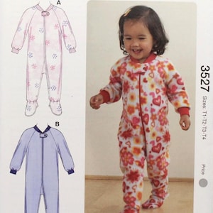 May include: Kwik Sew pattern 3527 for toddler sizes T1-T2-T3-T4. The cover shows a child wearing a floral print jumpsuit. The pattern includes illustrations of the jumpsuit design. The pattern is designed by Kerstin Martensson.