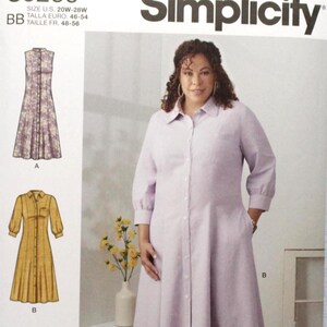 May include: Simplicity sewing pattern S9260 for a button-front shirt dress with a collar and three-quarter length sleeves. The envelope displays three variations of the dress in lavender, mustard yellow, and red with white polka dots, sized 20W-28W.