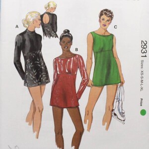 May include: A Kwik Sew sewing pattern, number 2931, featuring illustrations of three different figure skating dresses. The pattern includes sizes XS to XL. The cover has the Kwik Sew logo and the designer's name, Kerstin Martensson.