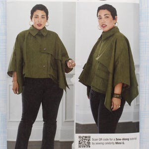 May include: Simplicity sewing pattern S9893 featuring a woman wearing a green cape-like jacket and black pants. The pattern includes sizes XS-XXL. The image includes the text "A DIY & LIFESTYLE BRAND" and "Simplicity".