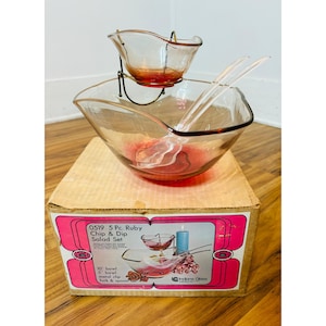 May include: A vintage 5-piece ruby chip and dip salad set. The set includes a large bowl, a smaller dip bowl on a metal stand, and serving utensils. The box reads "0519 5 Pc. Ruby Chip & Dip Salad Set".
