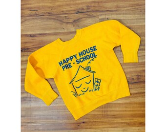 Sudadera infantil vintage de los años 70 con estampado gráfico en color amarillo dorado de Towncraft.