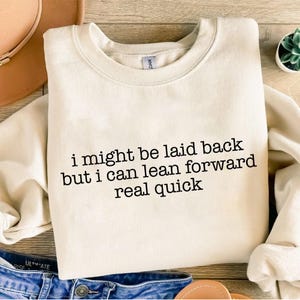 May include: A white ceramic mug with a black handle and the text "But first, coffee" in a handwritten style. The mug is on a white surface. The mug is 4 inches tall.