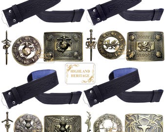 Könnte beinhalten: Eine Auswahl an schottischen Highland-Gürteln und -Schnallen. Das Bild zeigt schwarze Ledergürtel mit keltischen Knotenmustern sowie verschiedene Metallschnallen und Kiltnadeln. Die Schnallen zeigen Embleme wie eine Distel, einen Hirsch und ein Marine Corps-Emblem.