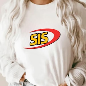 May include: White long-sleeve shirt with the word "SIS" in yellow letters outlined in black, inside a red and yellow curved design. The shirt is made of a soft material.
