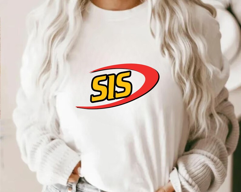 May include: White long-sleeve shirt with the word "SIS" in yellow letters outlined in black, inside a red and yellow curved design. The shirt is made of a soft material.