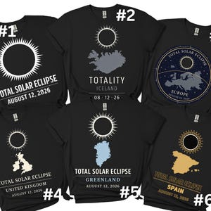 May include: Black t-shirts with white and gold solar eclipse designs. Each shirt features a different location: Iceland, Europe, United Kingdom, Greenland, and Spain. The text includes "Total Solar Eclipse" and the date August 12, 2026.