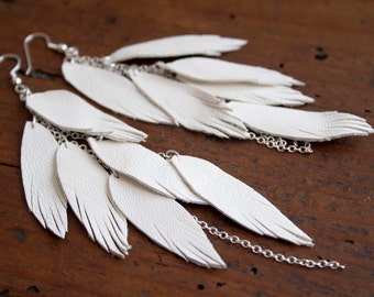 White Leather Feather Earrings Layered with chains.