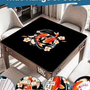 May include: A square wooden table with a black surface, decorated with a koi carp design. The table is surrounded by chairs. The image includes the text "Wide Range of Uses" at the top, and shows examples of the table being used for games.