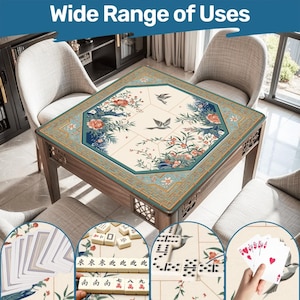 May include: A wooden table with a floral and bird design, suitable for various games. The table features a cream-colored surface with a teal border and decorative floral and bird motifs. The image includes playing cards, dominoes, and mahjong tiles.