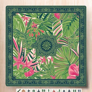 May include: Square decorative mat with a tropical leaf pattern in shades of green, pink, and white. The mat has a dark green border with a floral design. A set of Mahjong tiles are at the bottom.