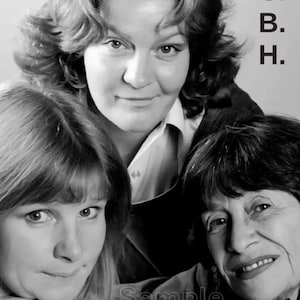 May include: Black and white portrait of three women. The central figure, with voluminous hair, is smiling. The image includes the text "P. C. B. H." on the right side and "Sample" at the bottom. The women are in a close-up shot.