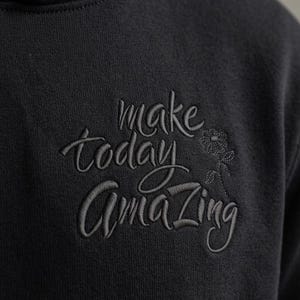 May include: A set of three ceramic mugs with a speckled, cream-colored glaze. Each mug features a different hand-painted floral design in shades of blue, green, and yellow. The mugs have a simple, rounded shape and a comfortable handle.