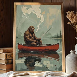 May include: A framed painting of a brown, hairy figure sitting in a red canoe on a lake. The figure is holding a fishing rod and is wearing a red bandana. The lake is surrounded by green trees and the sky is blue with white clouds.