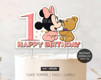 May include: Pink and white cake topper featuring a cartoon Minnie Mouse holding a teddy bear. The topper says "Happy Birthday" in pink and white letters.