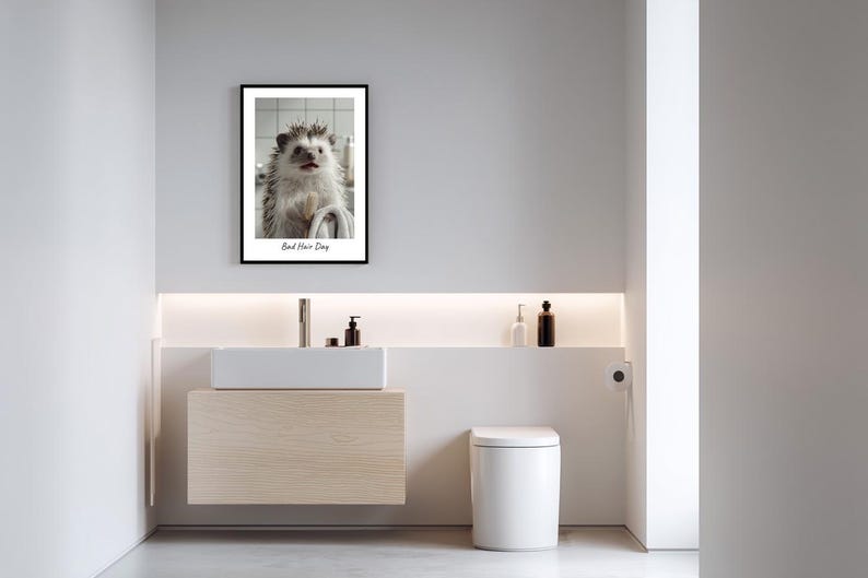 May include: A framed print of a hedgehog with wet fur, looking at the camera. The print is in a black frame and has the text "Bad Hair Day" below the image.