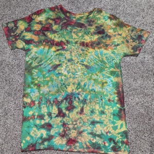 Size M. Green, aqua, red, yellow and tan colored reverse tie dye bleach dye T shirt