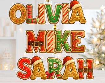 May include: Gingerbread-style Christmas ornaments spelling out the names Olivia, Mike, and Sarah. Each letter is decorated with festive icing, Santa hats, and holiday details. The ornaments hang from gold string.