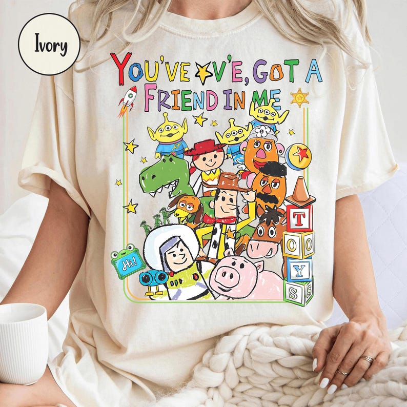 May include: A white ceramic mug with a black handle and the text "But First, Coffee" in a bold, black font. The mug is set against a neutral background, highlighting its simple design.