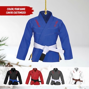 May include: A blue Jiu-Jitsu uniform ornament with a white belt and red text. The text "COLOR, YOUR NAME CAN BE CUSTOMIZED" is in a red banner. Additional colour options include black, red, grey, and white.