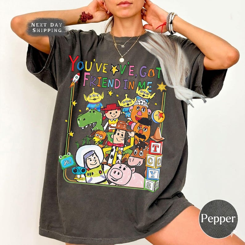 May include: A white ceramic mug with a black handle and the text "But First, Coffee" in a black, handwritten-style font. The mug is on a white surface.