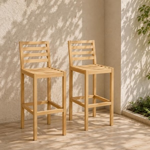 May include: Two wooden bar stools with a light brown finish. Each stool has a slatted back and seat, with a footrest. The stools are placed on a light-colored wooden floor, with a textured wall in the background.