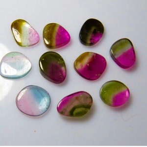 May include: Assortment of ten natural gemstone cabochons in various shades of green, pink, and white. The stones are smooth and polished, with a rounded, oval shape.