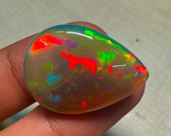 OPAL Welo Ethiopian - Rare Unique Pcs Best Quality -  Full Flash Galaxy Pin Fire - Pear Shape Cabochon  Size - 21x28 mm  Height - 8.5mm