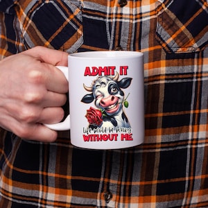 May include: White ceramic mug featuring a cartoon cow winking and holding a red rose. The mug has the text "ADMIT IT" above the cow and "life would be boring WITHOUT ME" below the cow.