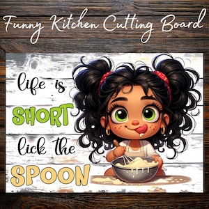 May include: A rectangular kitchen cutting board featuring a cartoon illustration of a child with dark curly hair in pigtails, holding a whisk in a bowl. The text reads: Funny Kitchen Cutting Board, life is SHORT lick the SPOON.