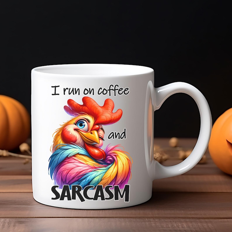 May include: White ceramic mug with a colorful rooster illustration and the text "I run on coffee and SARCASM." The rooster features vibrant red, blue, yellow, and purple feathers. The mug has a curved handle and is set against a wooden surface.