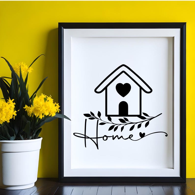 May include: A framed wall art print featuring a black line drawing of a house with a heart in the center, a leafy branch graphic, and the word Home written in cursive script with a small heart at the end, set against a bright yellow background.