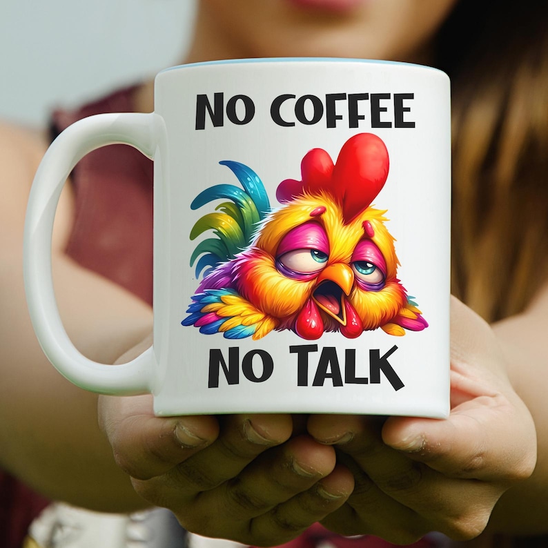 May include: White ceramic mug with a blue interior rim, featuring a colorful cartoon rooster with the text "NO COFFEE NO TALK". The rooster has red, yellow, blue, and orange feathers, with a sleepy expression.