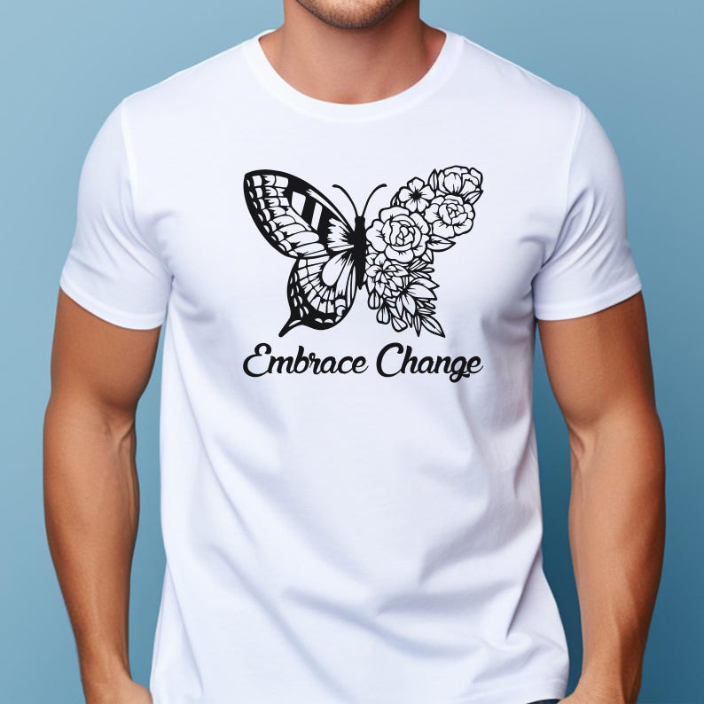 May include: White t-shirt with a black butterfly design, incorporating floral details. The words "Embrace Change" are printed beneath the butterfly. The shirt has a crew neck.