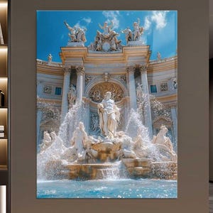 May include: A framed print of the Trevi Fountain in Rome. The artwork shows the baroque fountain with cascading water, sculptures, and a bright blue sky. The fountain is the central feature of the image.