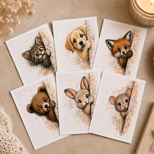 May include: Set of six greeting cards featuring watercolor illustrations of adorable animals peeking out from behind a textured surface. The animals include a kitten, puppy, fox, bear, bunny, and mouse. Each card has a unique animal design.