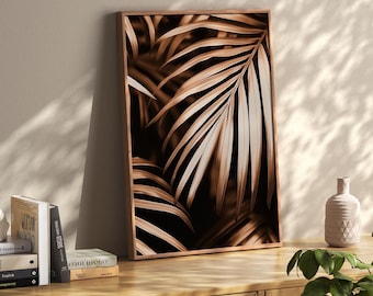 May include: A framed sepia-toned print featuring a close-up of palm leaves. The artwork showcases the intricate details of the leaves with varying shades of brown and beige. The wooden frame adds a natural touch to the botanical theme.