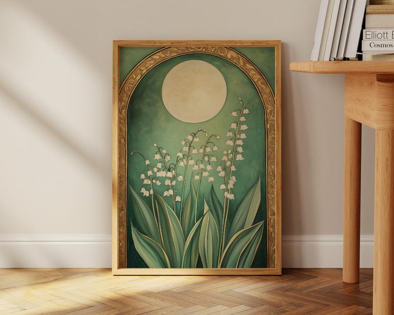 May include: A framed art print featuring a botanical illustration of lily of the valley flowers. The artwork has a vintage aesthetic with a green and gold color palette. The flowers are white, and the leaves are green.