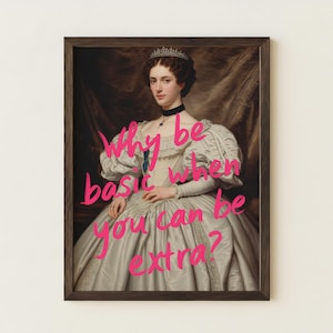 May include: A framed portrait of a person wearing a white gown with puffed sleeves, a tiara, and a black choker. The text Why be basic when you can be extra? is written in bright pink script across the center of the image in the dark wooden frame.