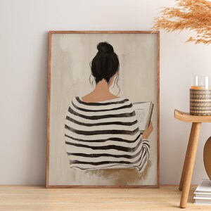 May include: A painting of a person with dark hair wearing a black and white striped shirt, sitting and reading a book. The background is a light beige color.