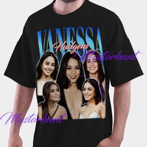 May include: Black t-shirt featuring a collage of images of Vanessa Hudgens. The word "VANESSA" is printed in a gradient blue font above the images, with "Hudgens" in a cursive font. The shirt is a casual style.