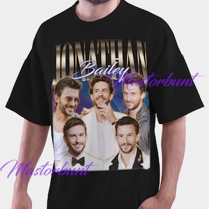 May include: Black t-shirt featuring a collage of five images of Jonathan Bailey. The design includes the name "Jonathan Bailey" in gold lettering with the name "Bailey" in cursive. The shirt is a classic crew neck.