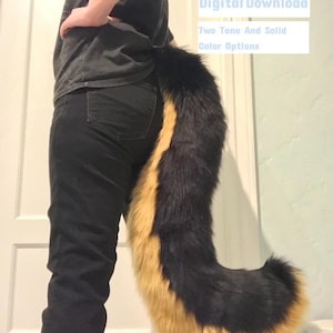 May include: A black and tan faux fur tail with a long, bushy tip. The tail is being worn by a person, and the image is labelled "Canine Tail Pattern, Digital Download, Two Tone And Solid Colour Options".
