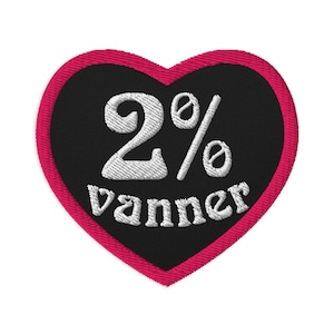 May include: A pink heart-shaped patch with black fabric in the center. The text "2% vanner" is embroidered in white on the black fabric.