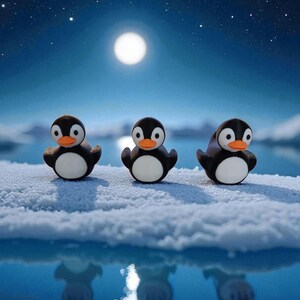 May include: Three penguin figurines with black bodies, white bellies, and orange beaks stand on a snowy surface. The background features a full moon, a starry sky, and a reflective blue body of water.